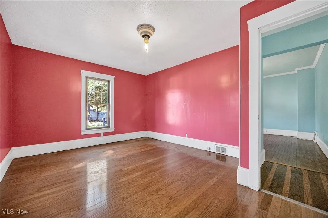 Spare room featuring wood finished floors and a textured ceiling