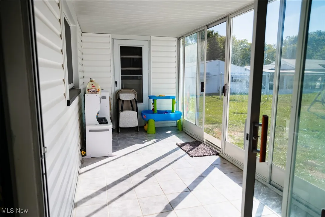 Sunroom / solarium with tile patterned flooring