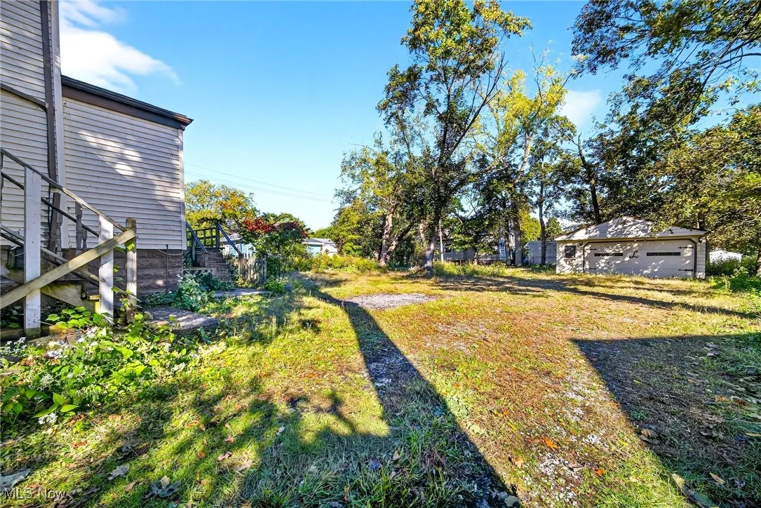 View of green lawn featuring stairs