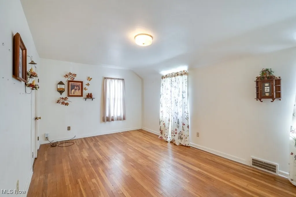 Empty room with light wood-style floors and baseboards