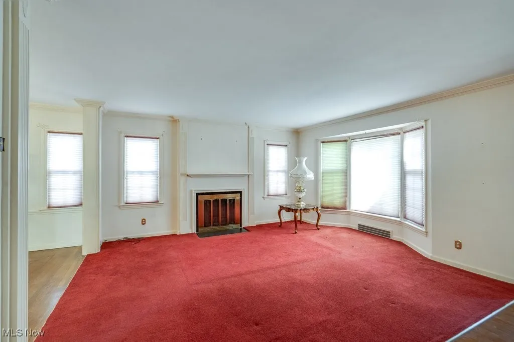 Carpeted living room featuring a fireplace