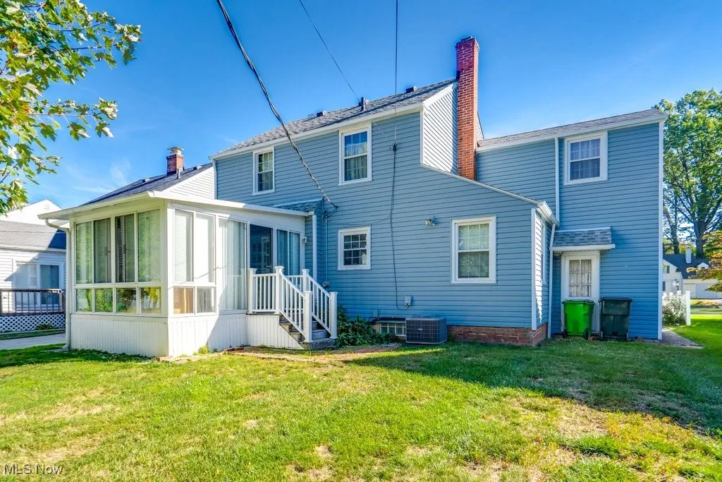 Back of house with a sunroom
