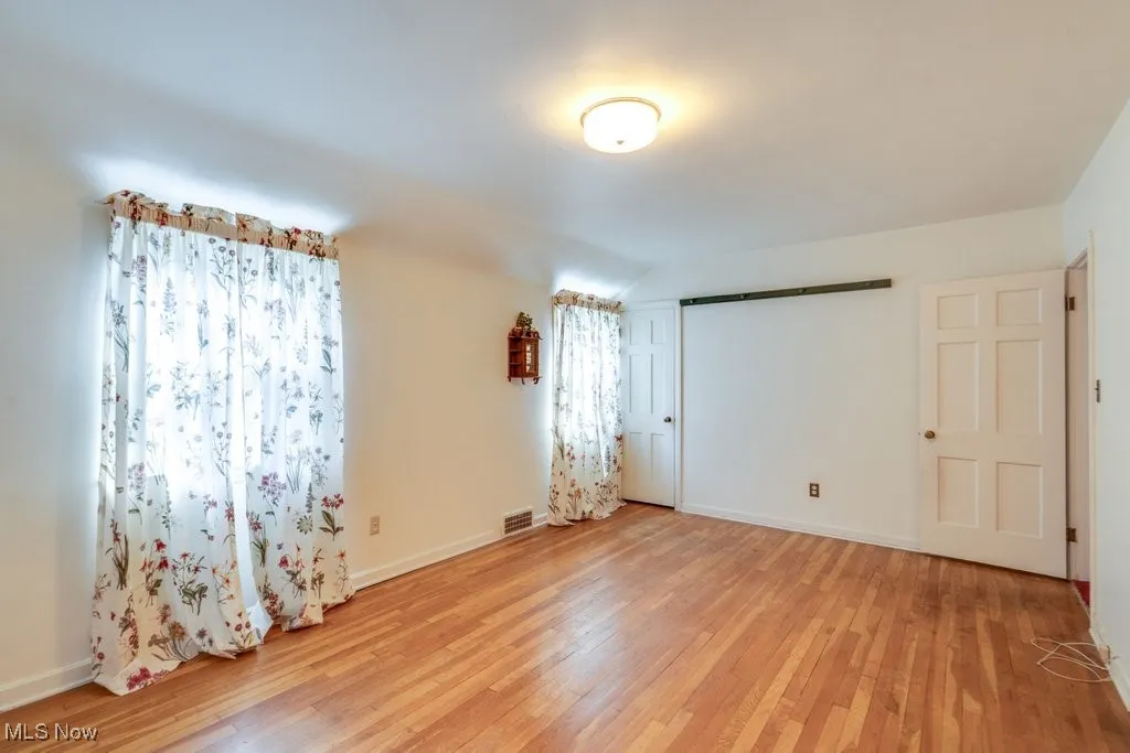 Unfurnished bedroom featuring light wood-type flooring