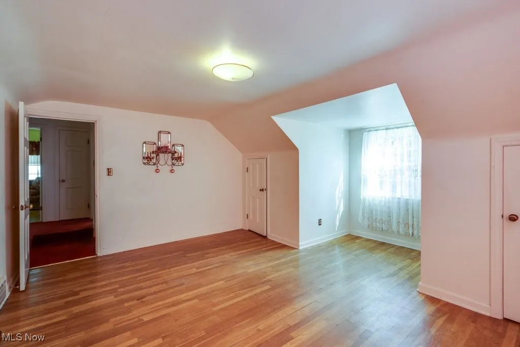 Additional living space featuring light wood finished floors