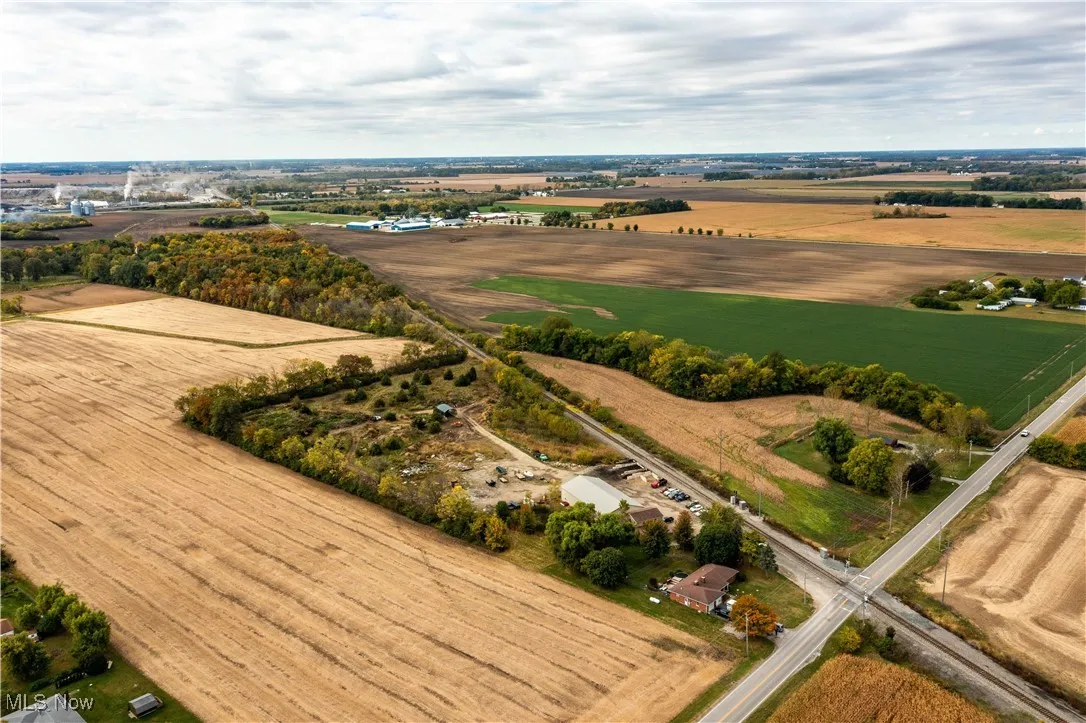 Aerial view of sparsely populated area with rows of crops