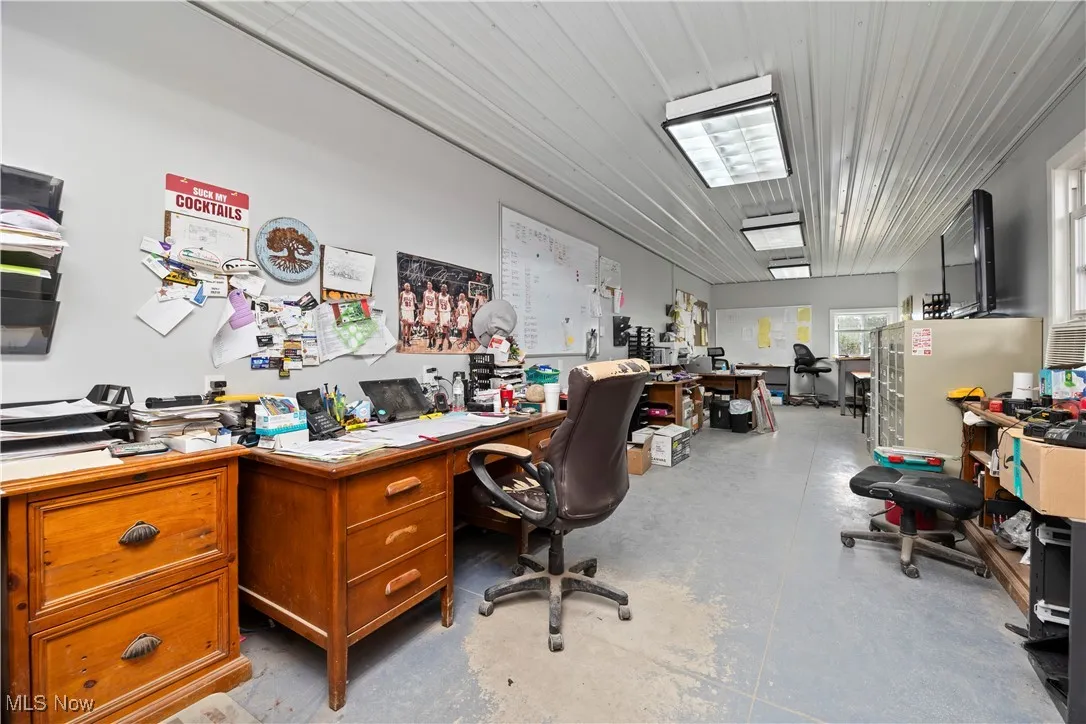 Office area featuring concrete floors