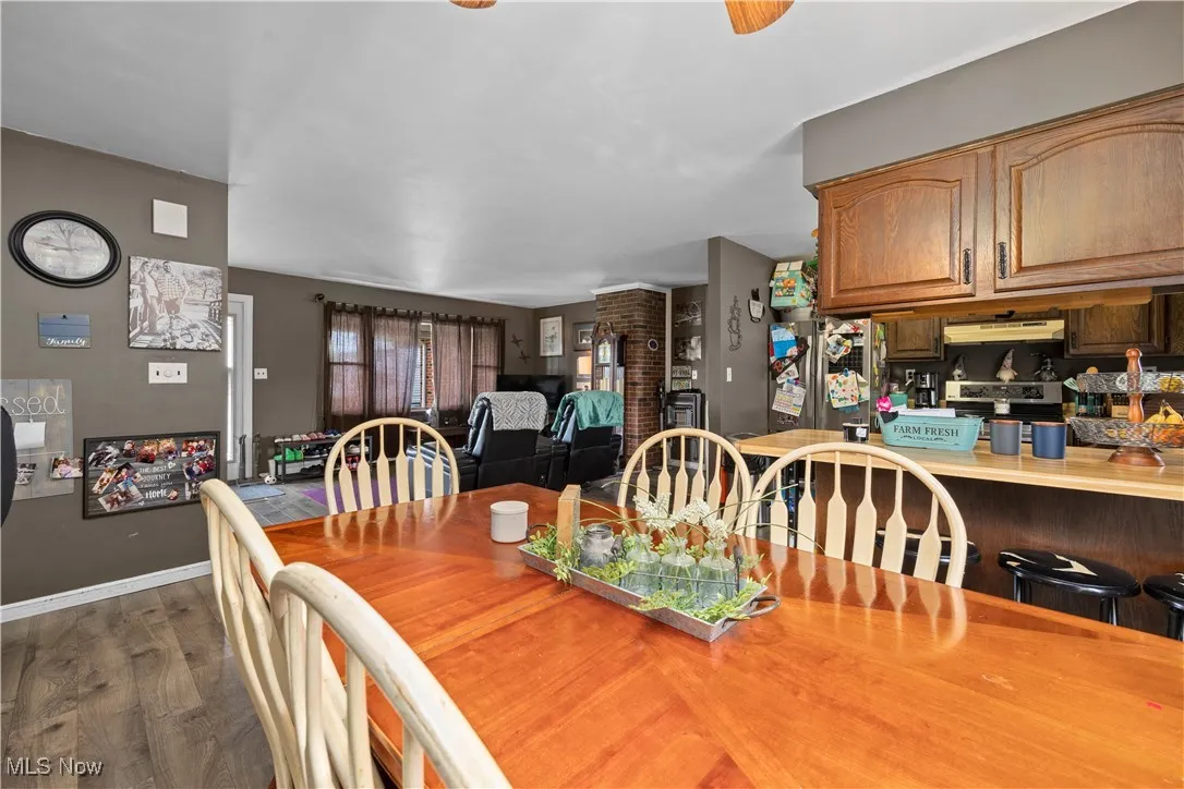 Dining space featuring dark wood-style flooring and baseboards