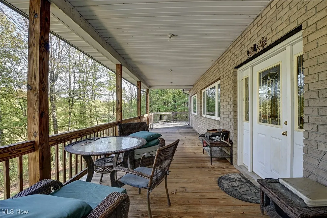 Sunroom with outdoor dining area and covered porch