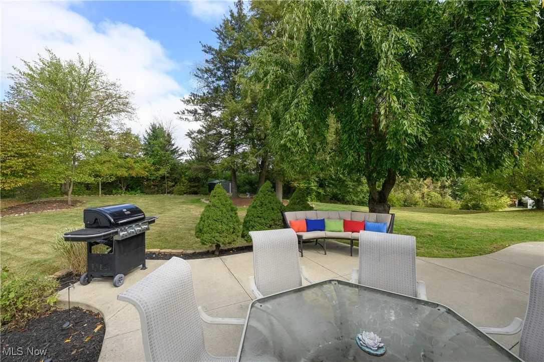 View of patio with area for grilling and an outdoor hangout area