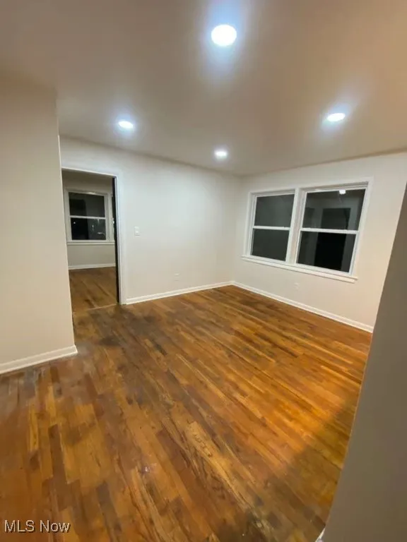 Unfurnished room featuring dark wood-style floors and recessed lighting