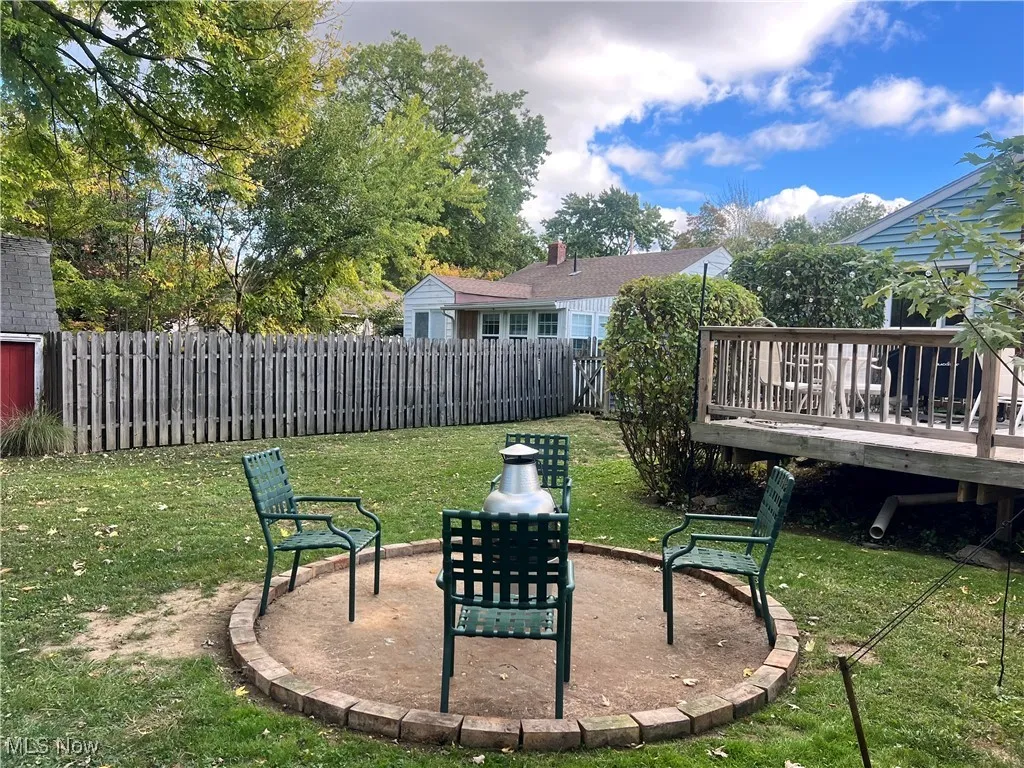 View of yard with a wooden deck and an outdoor fire pit