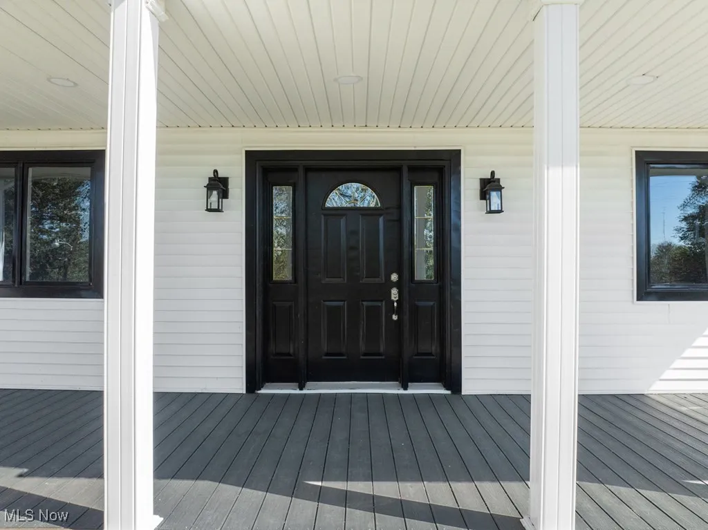 Doorway to property with covered porch