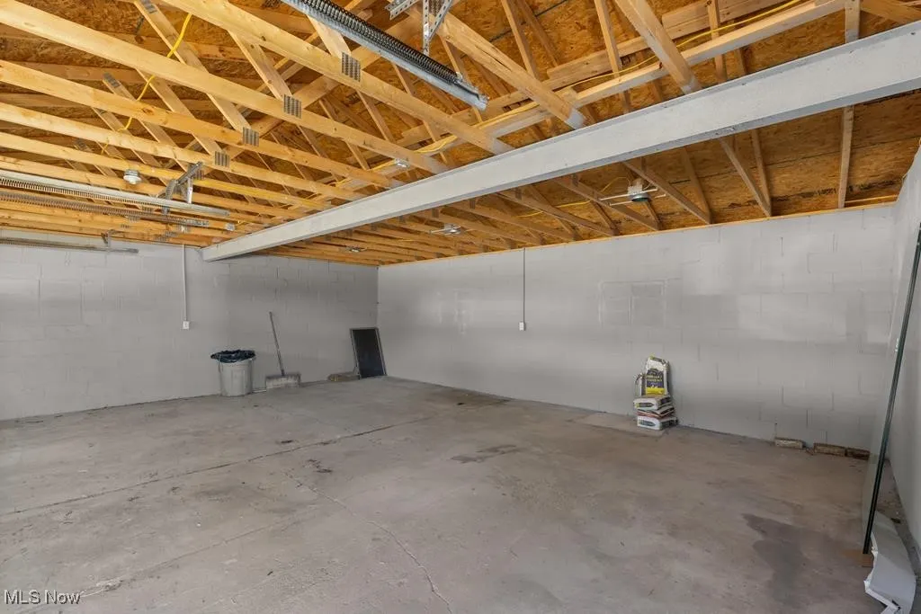 Below grade area with concrete block wall and a garage