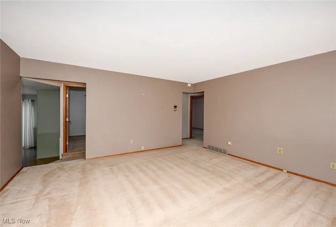 A couple steps lead from Living Room to custom Kitchen, 3rd Bedroom & Basement