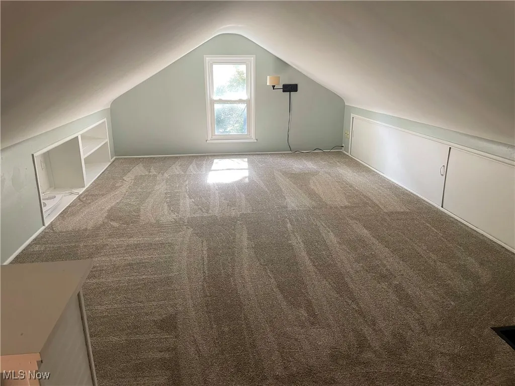Bonus Room / 4th Bedroom featuring carpet flooring and lofted ceiling