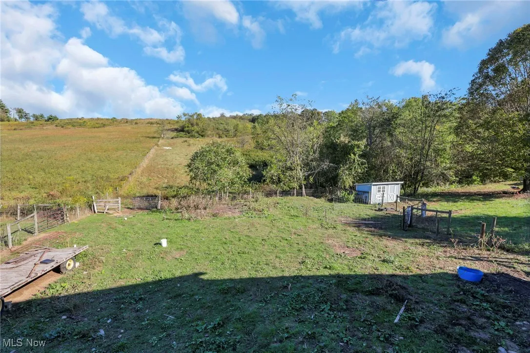 View of yard featuring a view of countryside and an outdoor structure