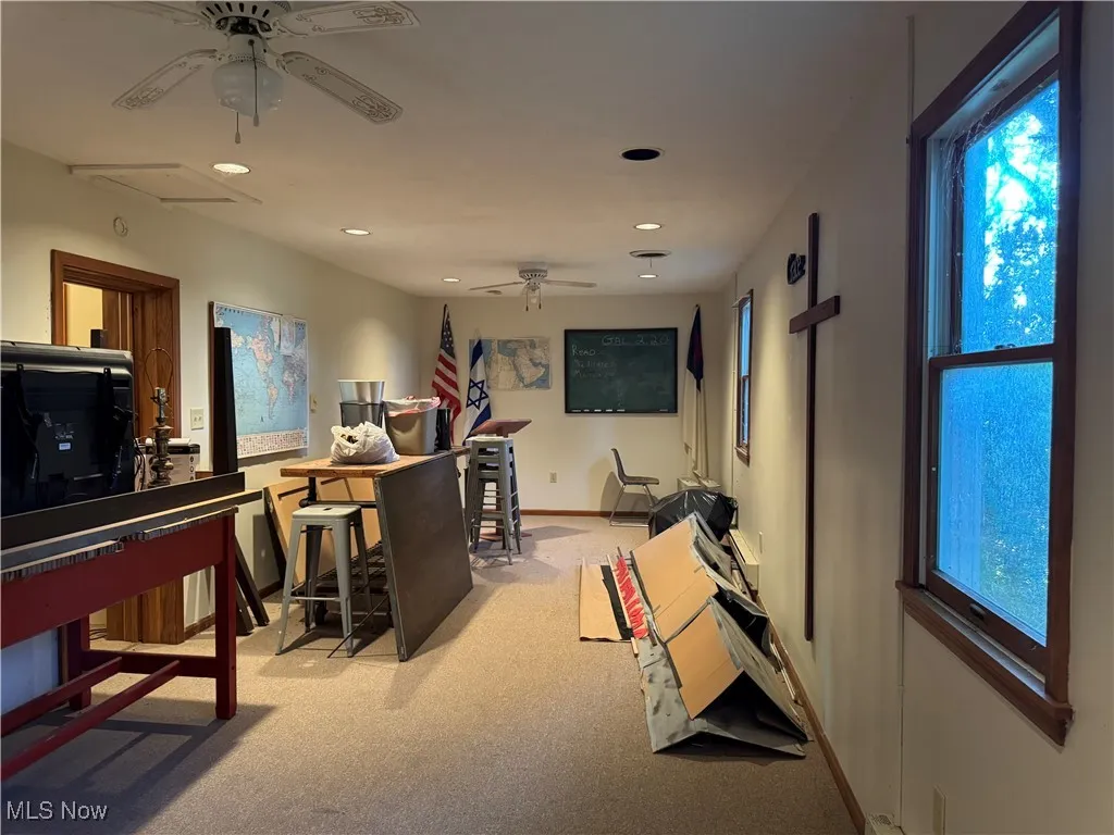 Workout room with a ceiling fan, light carpet, and recessed lighting