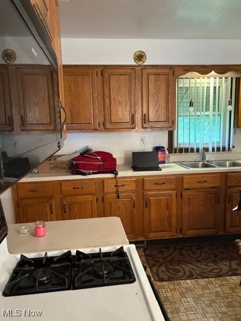 Kitchen featuring brown cabinets and light countertops