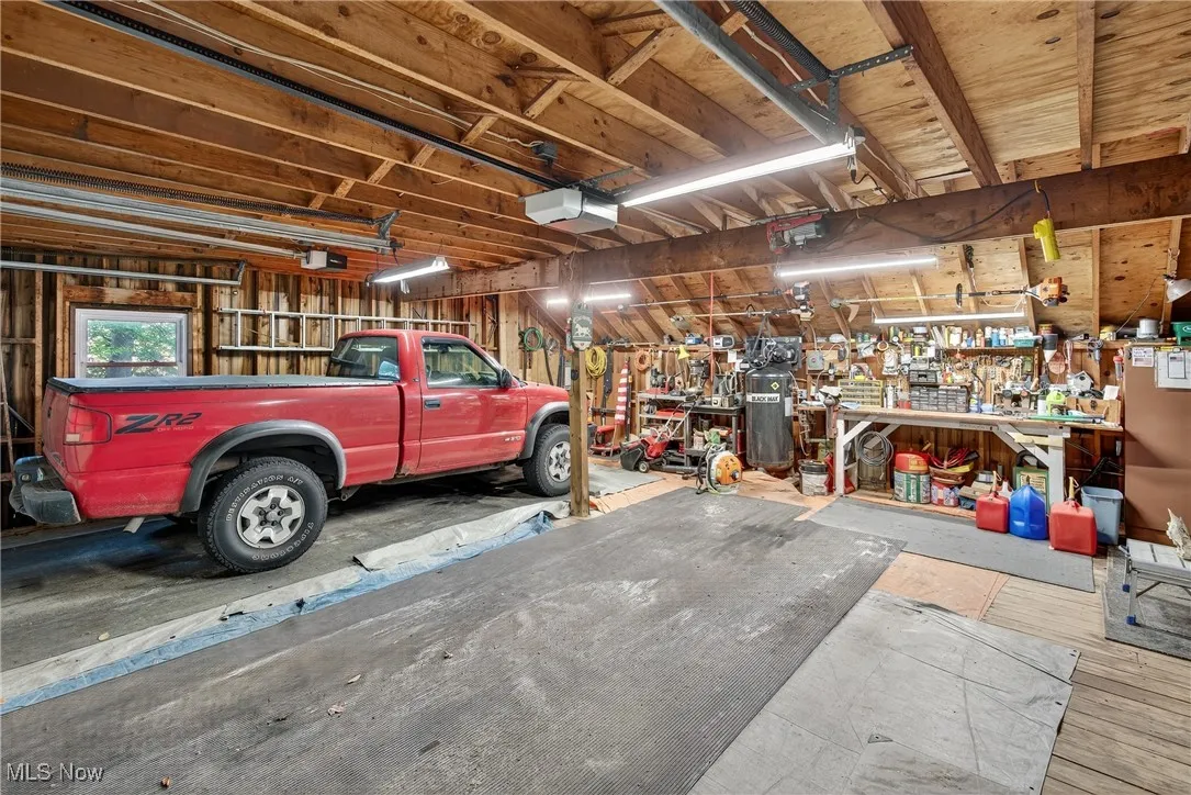 Garage with a workshop area and a garage door opener