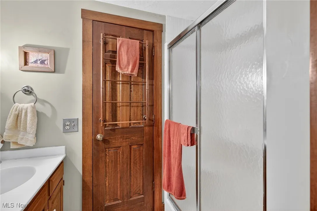 Full bath with vanity and a stall shower