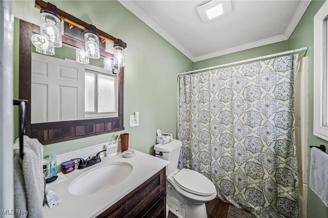 Bathroom with crown molding and vanity