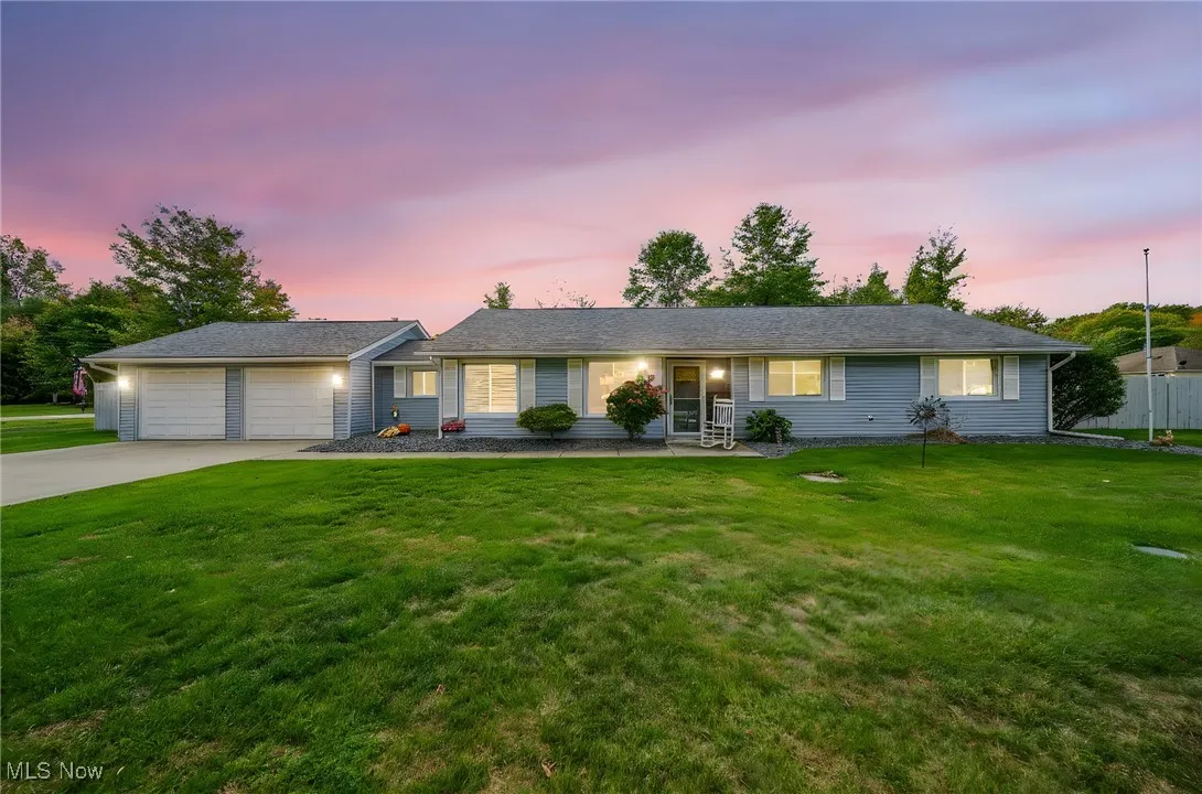 Single story home featuring a front lawn, concrete driveway, and a garage