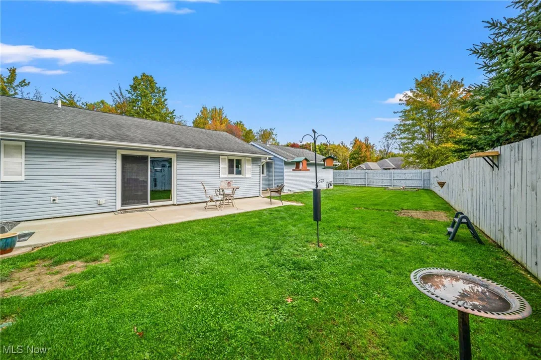 Fenced backyard with a patio area
