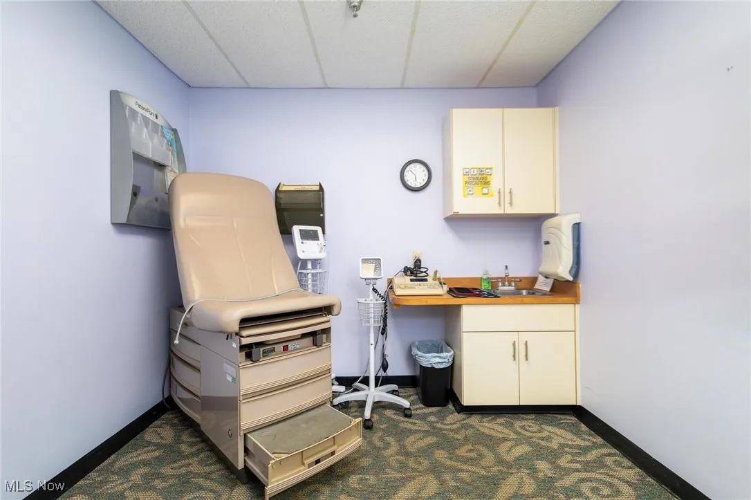 Office space featuring a drop ceiling and a sink