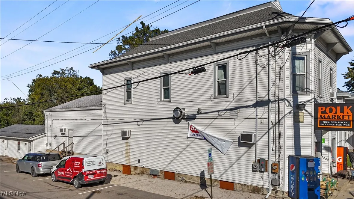 View of property exterior with roof with shingles and crawl space