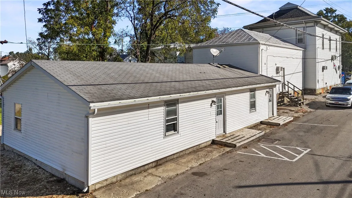 View of front of property with a shingled roof