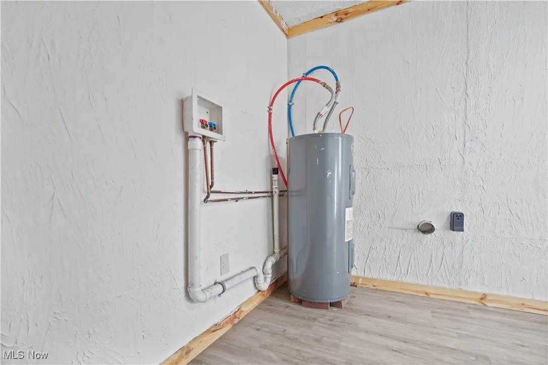 Utility room featuring electric water heater