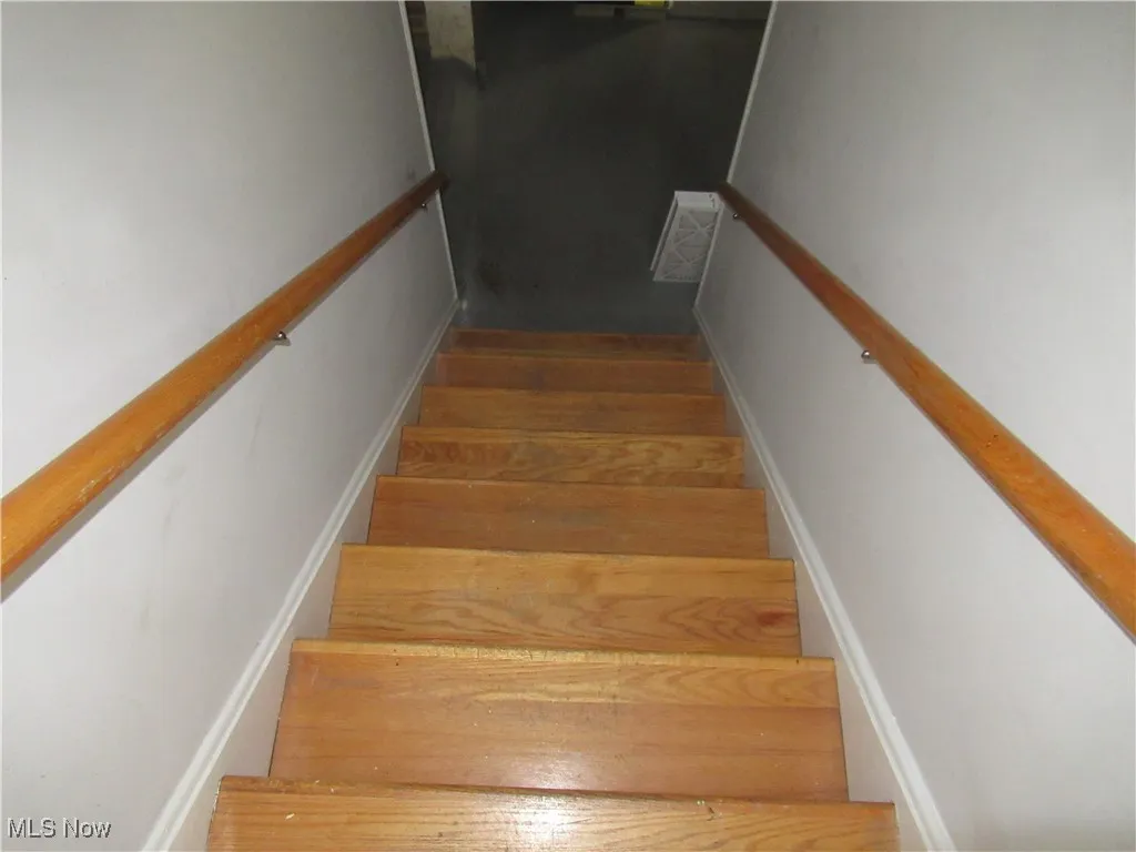 Staircase with hardwood / wood-style floors