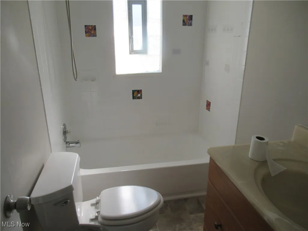 Full bathroom featuring vanity and shower / bath combination