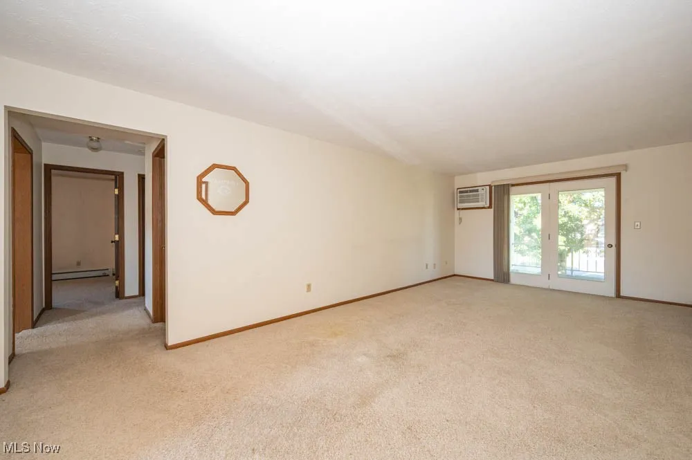 Large living room that leads to covered balcony