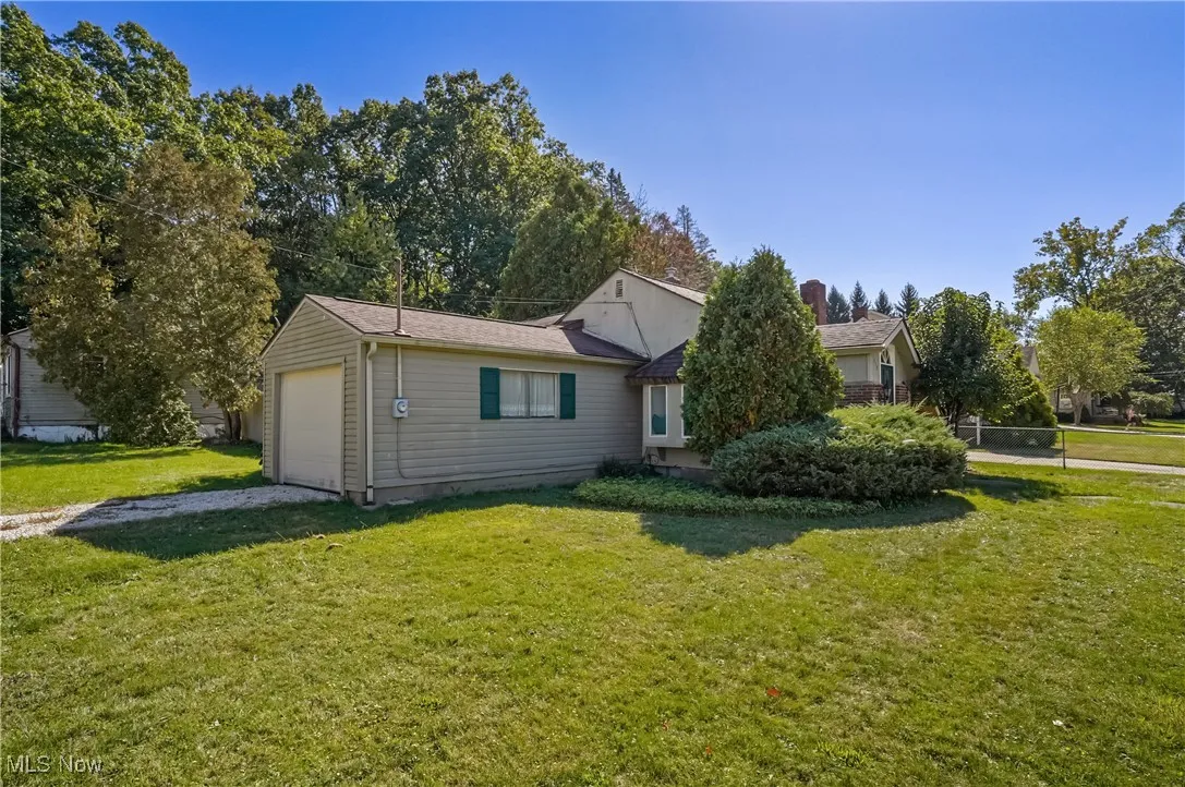 View of front of home with a front lawn, driveway, and an attached garage