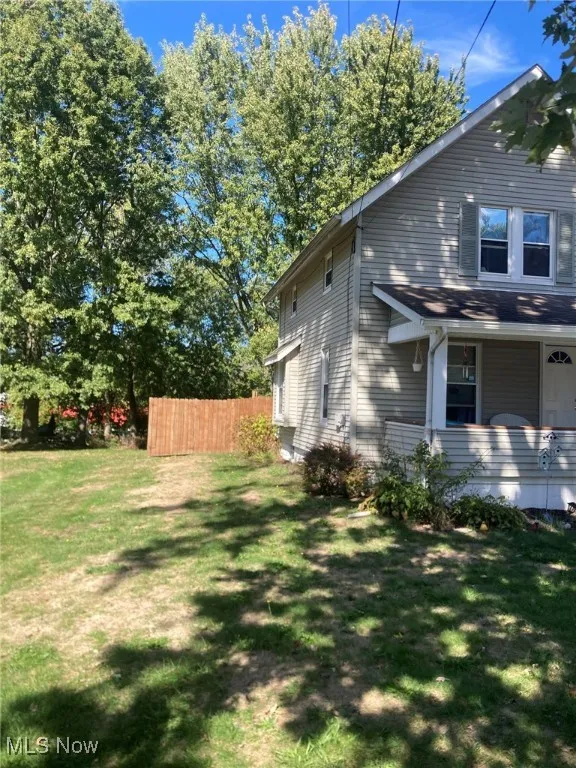 View of side of home with a porch
