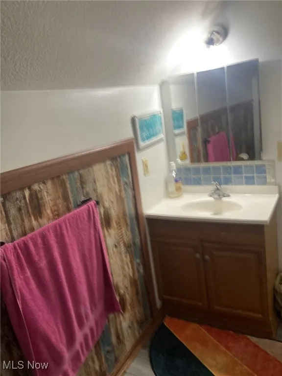 Bathroom with vanity and a textured ceiling