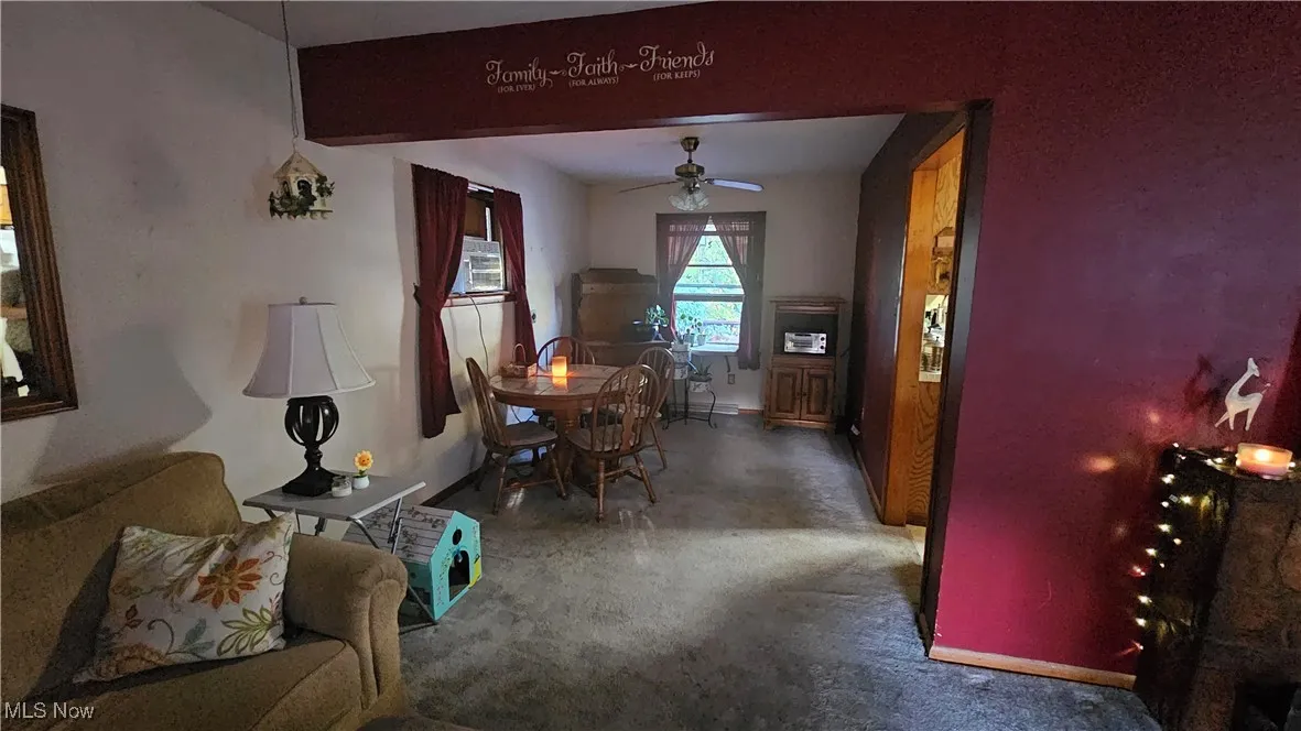 Dining room featuring ceiling fan and baseboards