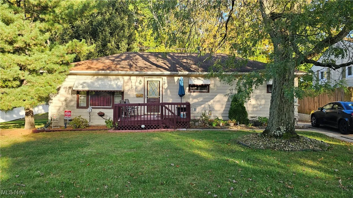 View of front facade featuring a deck and a front lawn