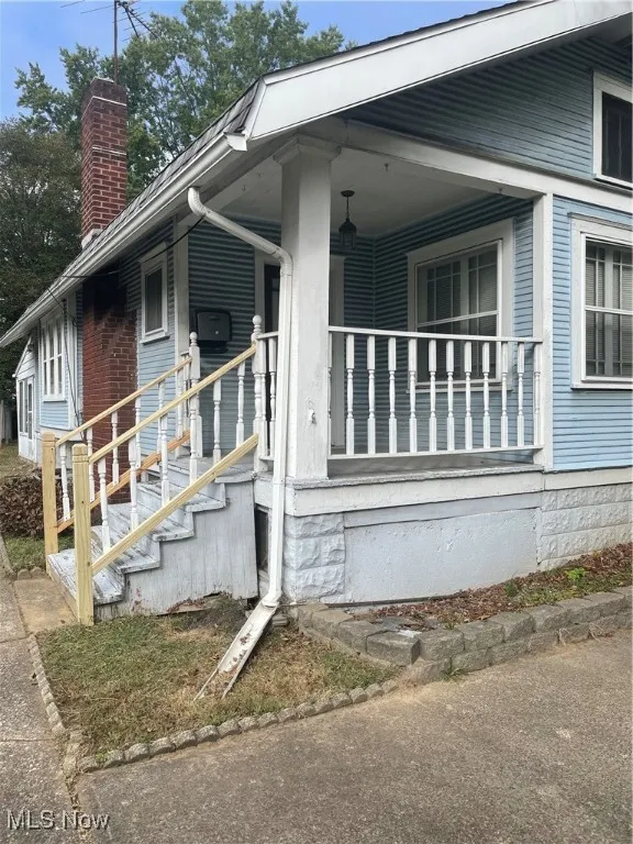 View of property exterior featuring a chimney