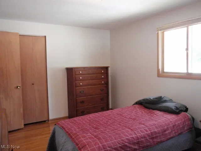 Bedroom featuring a closet and light wood-style flooring