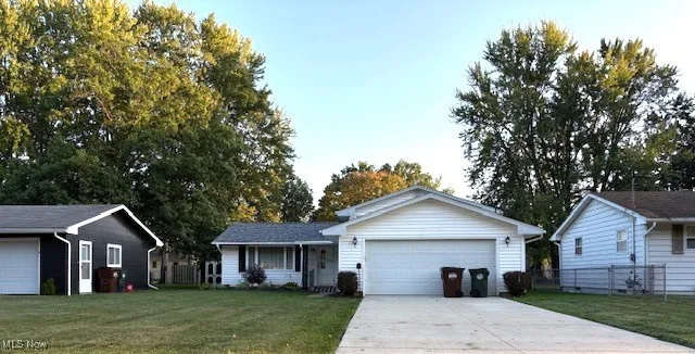 Split Level home with concrete driveway and covered porch