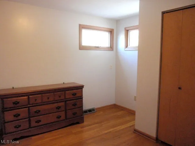 Bedroom featuring light wood-style flooring and a closet