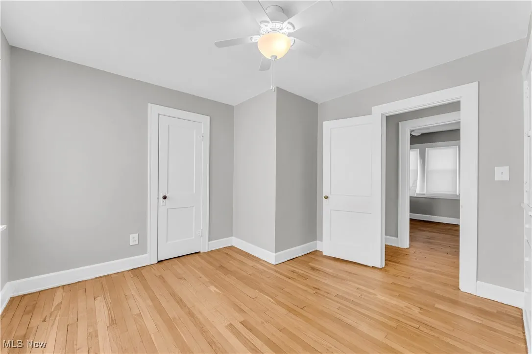Unfurnished bedroom featuring light wood-style floors and ceiling fan
