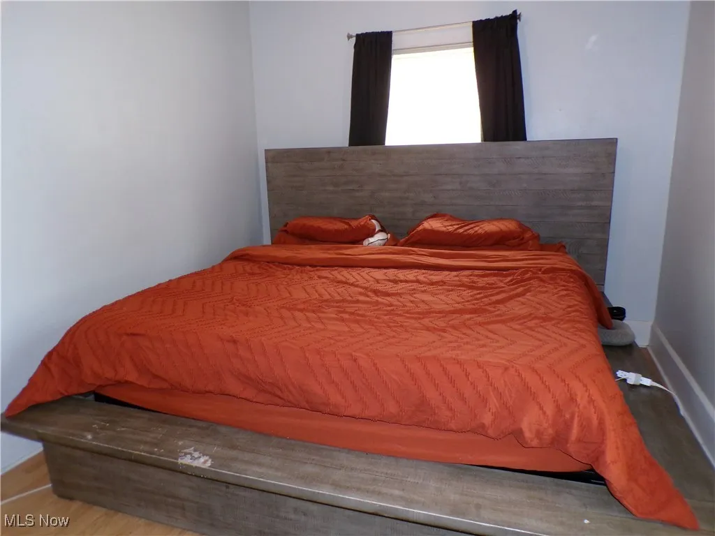 Bedroom #1 with baseboards and wood finished floors