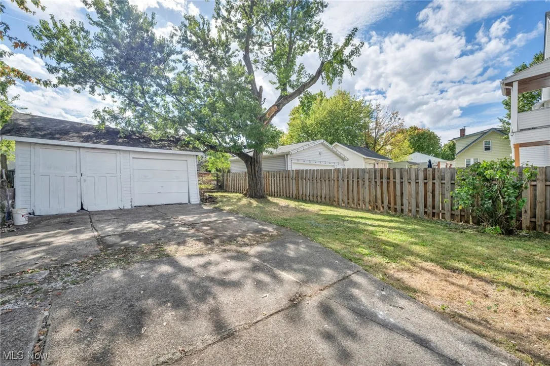 View of yard featuring an outbuilding and a detached garage