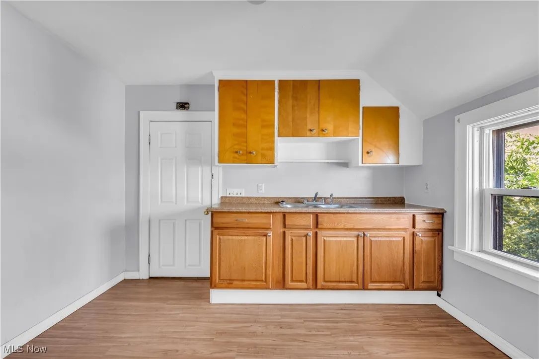 Kitchen featuring light wood finished floors and brown cabinetry