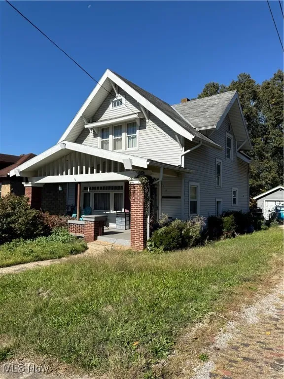 View of side of property with covered porch