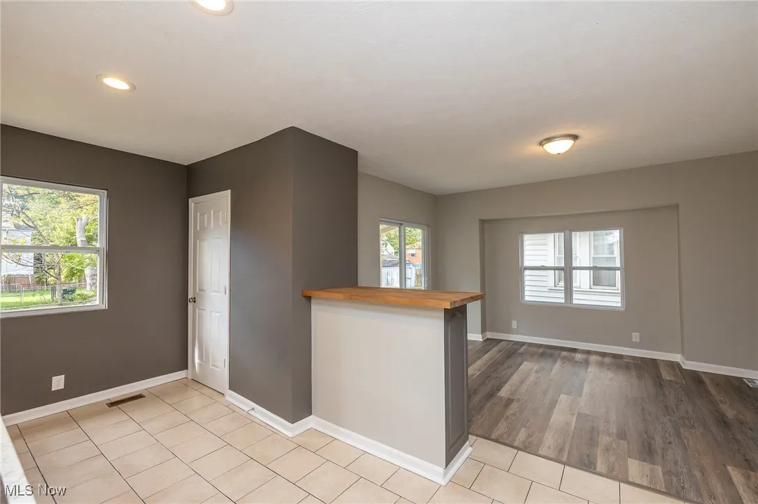 Kitchen with wood counters, a peninsula, and light tile patterned floors