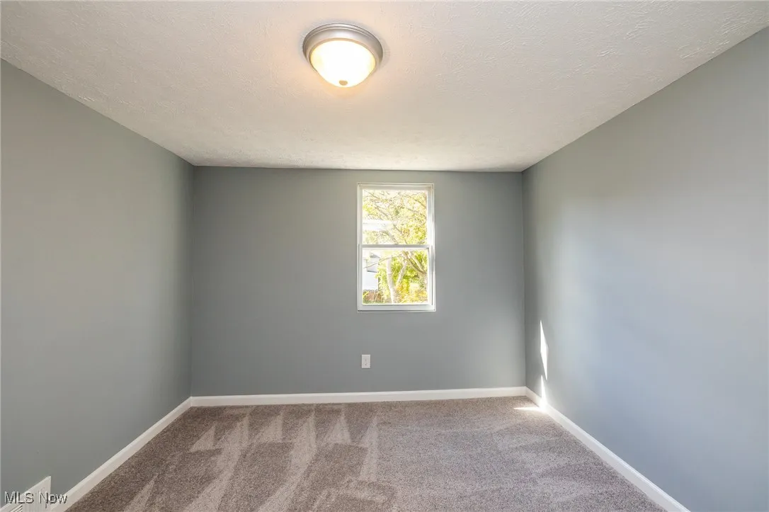 Bedroom with new carpet and a textured ceiling all new paint
